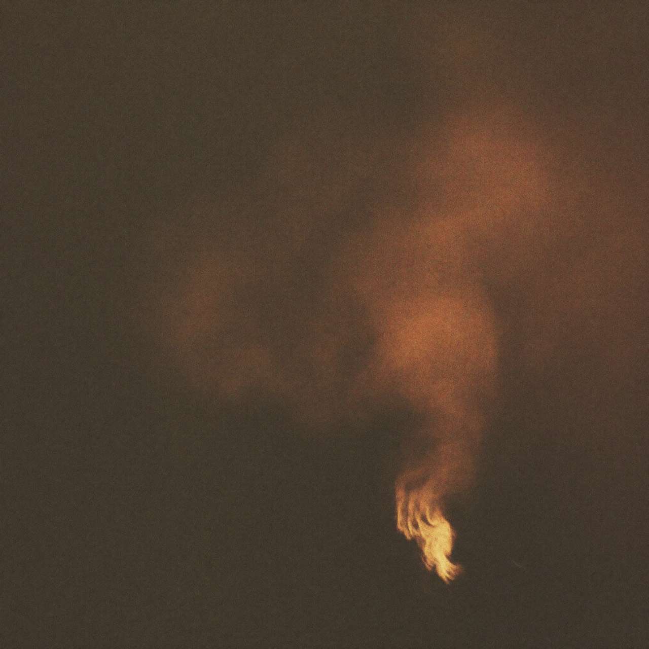 Ember-lit smoke rising through darkness